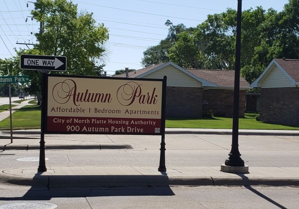 Third slide. Picture of autumn park's sign.